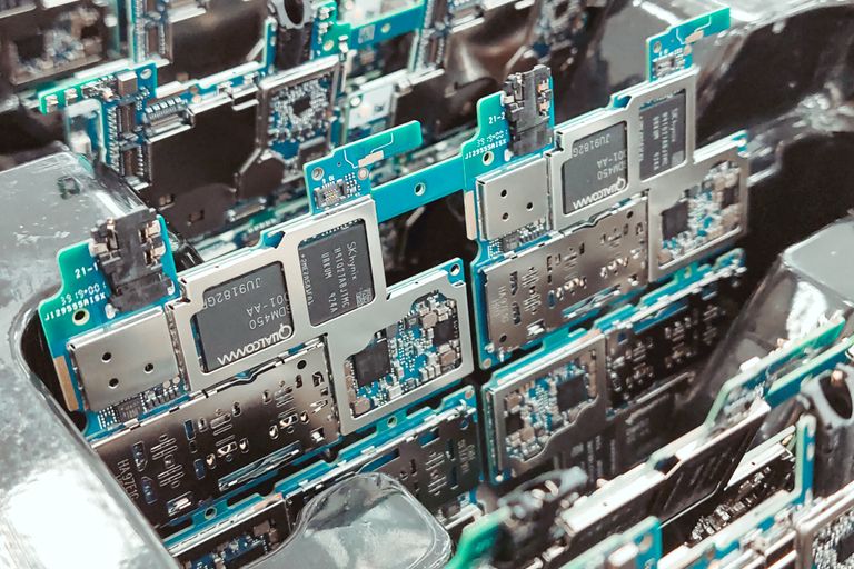 Close-up of intricate circuit boards in a Vietnamese factory, capturing modern electronics production.
