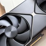 Close-up of a high-performance graphics card with detailed cooling fan design, ideal for tech enthusiasts.